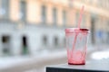 Empty dirty plastic cup and cocktail straw outdoor