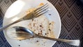 Empty dirty plate, glasses, a plates remained after eating and drinking drinks on a wooden table in the rays of the bright Royalty Free Stock Photo