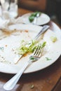 Empty dirty plate left after dinner on table Royalty Free Stock Photo
