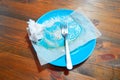 Empty dirty plate on wooden table left after lunch Royalty Free Stock Photo