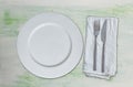 Empty dish and cutlery on green white wood