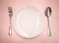 Empty dish with spoon and fork Royalty Free Stock Photo