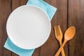 Empty dish, Wooden spoon and fork on wooden background Royalty Free Stock Photo