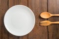 Empty dish, Wooden spoon and fork on wooden background Royalty Free Stock Photo