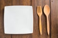 Empty dish, Wooden spoon and fork on wooden background Royalty Free Stock Photo