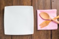 Empty dish, Wooden spoon and fork on wooden background Royalty Free Stock Photo