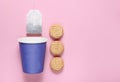 Empty disposable paper cup for tea, tea bag, cookies on pink pastel background, top view, minimalism. Royalty Free Stock Photo