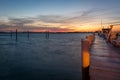 Empty Dock Extending into a Harbor at Sunset