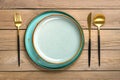 empty double round blue and gray plate, fork, knife, spoon on wooden table Top view Flat lay Dishes for breakfast, lunch or dinner Royalty Free Stock Photo