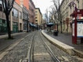 An empty downtown street looking straight down the trolley tracks, on a quiet winter day in Portland, Oregon, United States