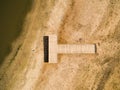 Empty Dried Pier with Beach Goer Below