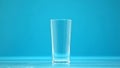 Empty drinking cup, glass for milk and water on blue background, zero calorie Royalty Free Stock Photo