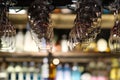 Empty drinking glasses hanging upside down in bar rack at dark night Royalty Free Stock Photo