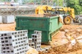 An empty dumpster for construction waste debris near a construction site is loaded up with debris Royalty Free Stock Photo