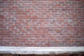 Empty dusty dirty wooden table with the blurred brickwork wall in background