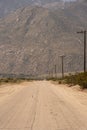 Empty, dusty road in the middle of nowhere Royalty Free Stock Photo