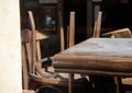 Empty dusty vacant pub, bar or cafe wooden chairs and tables, furniture detail, nobody no people, closed local bar, restaurant