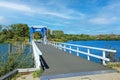Empty dutch bicycle and pedestrian bridge over lake in summer - Thorn (Heggerplas), Netherlands