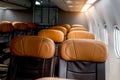 Empty economy class seats in the cabin on airplane next to the window, holiday vacation traveling or business trip airplane Royalty Free Stock Photo