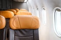 Empty economy class seats in the cabin on airplane next to the window, holiday vacation traveling or business trip airplane Royalty Free Stock Photo