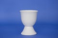 An empty egg cup on a blue background Royalty Free Stock Photo