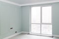 Empty elegant mint colored room with boiserie on the walls and panoramic Windows with a con in the floor