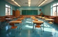 Empty elementary school classroom with rows of desks and chairs. Bright windows cast sunlight on teal floor. Green chalkboard Royalty Free Stock Photo