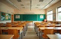 Empty elementary school classroom with rows of desks, chairs. Green chalkboards on walls display student artwork, learning Royalty Free Stock Photo