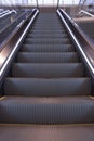 Empty escalator in the airport. Electric staircase in perspective. Mode of transportatioin. Empty elevator in modern building.