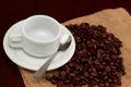 Empty espresso cup on roasted coffee beans on burlap bag Royalty Free Stock Photo