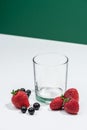 Empty even glass with fresh strawberries nearby Royalty Free Stock Photo