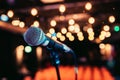 Empty event hall: Close up of microphone stand, empty seats in the blurry background Royalty Free Stock Photo