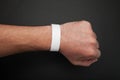 Empty event ticket wrist band design. Concert blank paper wristband, bracelet mockup on black background