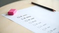 Empty exam desk with multiple-choice answer sheet, sharpened pencil, and eraser Royalty Free Stock Photo