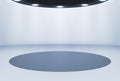 Empty exhibition space against a studio background in a modern simple minimalist design with a round illuminated pedestal Royalty Free Stock Photo