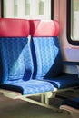 Empty fabric blue red seats close-up, interior inside passenger trains or rail tram, public transportation Royalty Free Stock Photo