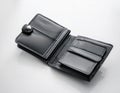 Empty fabric wallet with metal clasp lying open on a pure white background revealing its interior features