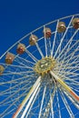 Empty ferris wheel in bavaria against clear blue sky.