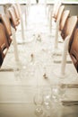 Empty fine dining room table arranged for dinner in fancy restaurant. Above view of glass dishes, cups, wineglasses Royalty Free Stock Photo