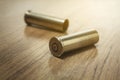 Empty fired .357 magnum bullet shells on the wooden house floor Royalty Free Stock Photo