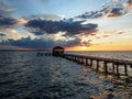 Fishing pier and dock silhouetted in a colorful sunset Royalty Free Stock Photo