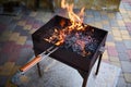 Empty flaming charcoal grill with open fire, ready for product placement. Summer grilling, barbecue, bbq and party. Royalty Free Stock Photo