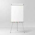 Empty flip chart whiteboard stand with markers for presentation Royalty Free Stock Photo