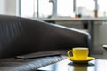 Empty folder on an office couch next to a coffee table