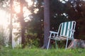 Empty folding camp chair for relaxing on the field near the forest Royalty Free Stock Photo