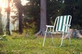 Empty folding camp chair for relaxing on the field near the forest Royalty Free Stock Photo