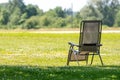 Empty folding garden chair on the lawn of the country house Royalty Free Stock Photo