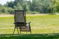 Empty folding garden chair on the lawn of the country house Royalty Free Stock Photo