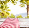 Empty food table,red tableclothes on blurred summer park background, copy space