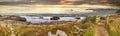 Empty foot path and wooden bridge on ocean beach trail with dark sky in panoramic format.